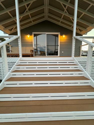 a front porch of a house with a wooden deck at Eden Explorer - Beach - Bike - Hike - Fish in Eden