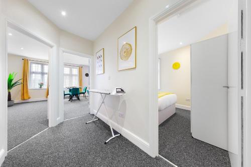a bedroom with a bed and a desk in a room at Stylish & Modern 2-Bedroom London Hideaway - King Bed- Sleeps 6 - Parking Available - Instant Book - 20 Percent Off Long Stays! in Barnet