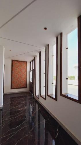 an empty room with windows and a painting on the wall at Hotel MD Grand in Agra