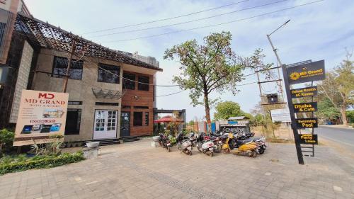 a group of motorcycles parked in front of a building at Hotel MD Grand in Agra