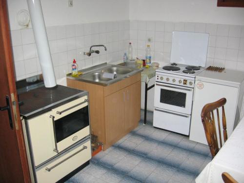 a kitchen with a sink and a stove at Guest house Pribojska Banja in Pribojska Banja