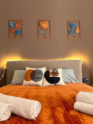 a bedroom with a bed with pillows on it at Pura Vida Apartment in Catania