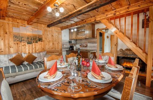 a wooden dining room with a table and a couch at Holiday Home David in Slunj