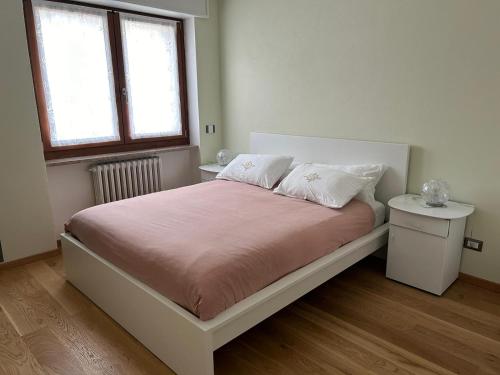 a bedroom with a bed with two pillows and a window at Casa Dolce Casa in Masera