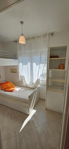 a bedroom with a bed and a window at Apartman Doris in Dramalj