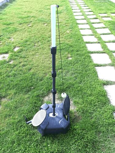 a golf implement sitting on the grass near a path at MILAN Domki Mielno in Mielno