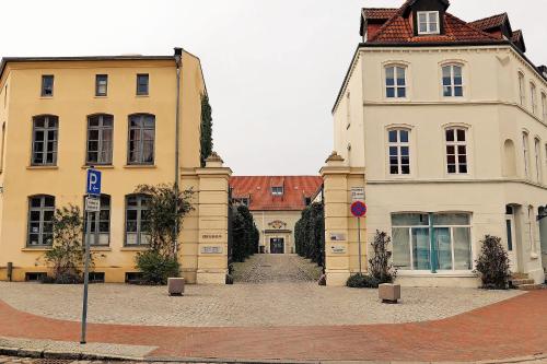 due edifici su una strada con un cartello stradale davanti di Altstadtsonne 1 - ABC33 a Wismar