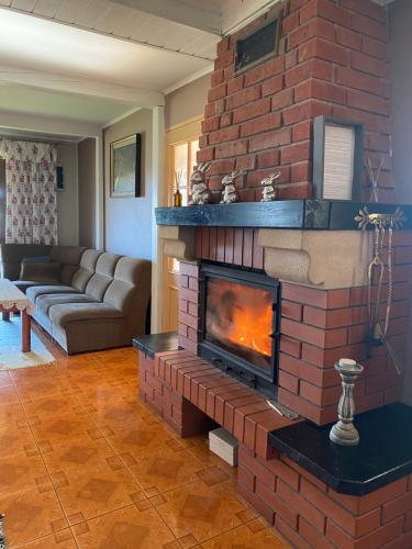 a brick fireplace in a living room with a fire place at Polana in Lipowiec