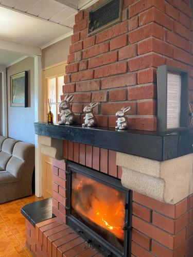 a brick fireplace with two rabbits on top of it at Polana in Lipowiec