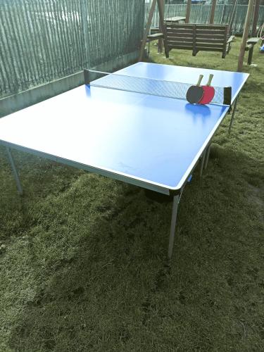 a ping pong table with two ping pong balls on it at MILAN Domki Mielno in Mielno