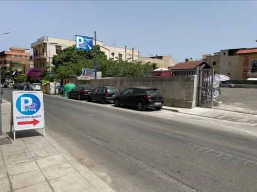 a parking lot with cars parked on the side of a street at Casa Giusi in Sferracavallo