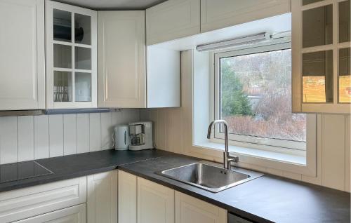 a kitchen with a sink and a window at Lovely Home In Frekhaug With Wifi in Alversund