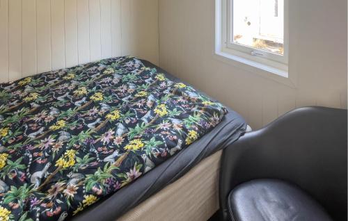 a bed in a room with a blanket on it at Lovely Home In Frekhaug With Wifi in Alversund