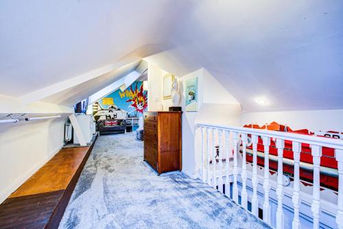 a white room with a crib and a bedroom at Entire artistic open-apartment in Southend-on-Sea