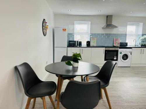 a kitchen with a table and chairs in a room at A unique spacious 2-Bed Apartment in North London in London