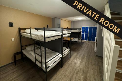 a row of bunk beds in a room at Xplore Hostel Amsterdam in Amsterdam