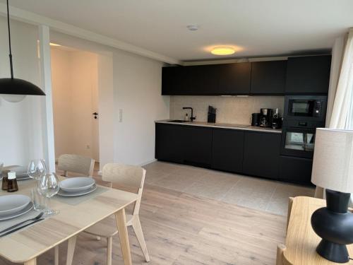 a kitchen and dining room with a table and chairs at Weststrandhaus in Großenbrode
