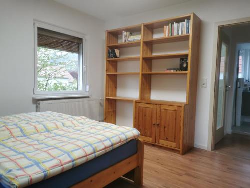 a bedroom with a bed and a book shelf at Ferienhaus Marla in Schwebda