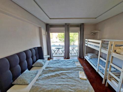 a bedroom with two bunk beds and a balcony at Obrigado Lisboa in Lisbon