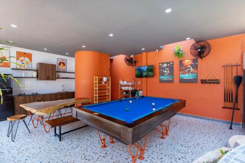 a pool table in a room with orange walls at Wabi Sabi Villa * Hồ Bơi Thác Nước 140 m2 * Phòng Karaoke Thủy Cung in Vung Tau