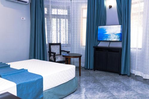 Ένα ή περισσότερα κρεβάτια σε δωμάτιο στο Velmont Hotel