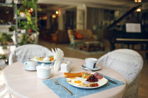 a table with a plate of breakfast food on it at Kenari Hotel in Tbilisi City
