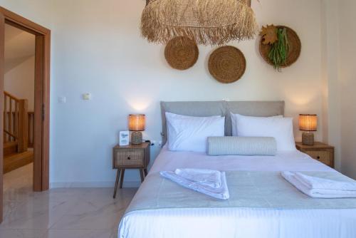 a bedroom with a bed with two towels on it at Anelia Serene Villa in Sfakaki