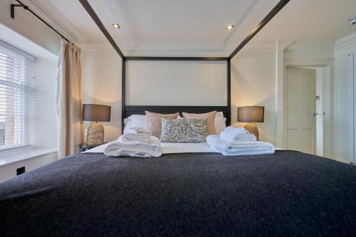 a bedroom with a large bed with towels on it at Wilding Hotel in Brough
