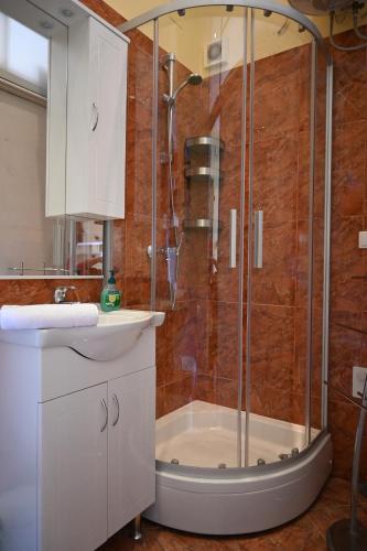 a bathroom with a shower and a sink at Apartment King in Opatija