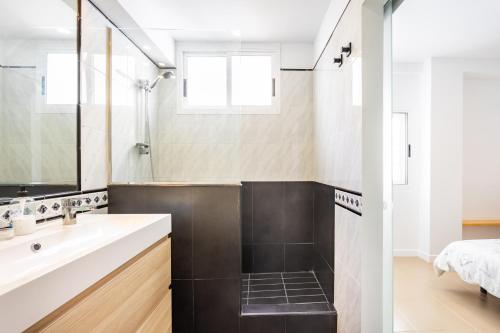 a bathroom with a sink and a mirror at Home2Book Pleasant & Design Apt Santa Cruz Center in Santa Cruz de Tenerife