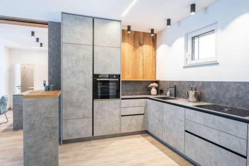 a kitchen with stainless steel cabinets and a sink at Arbio Penthauser-Lorenzerhof in Murau