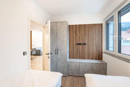 a bedroom with a bed and a large window at Arbio Penthauser-Lorenzerhof in Murau