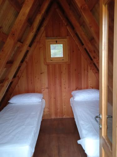 a room with two beds in a attic at Parco Archeologico Valdieri in Valdieri