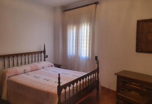 a bedroom with a bed and a window at APARTAMENTOS EL PORTAL in Mora de Rubielos