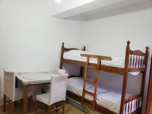 a room with two bunk beds and a table and chair at Hotel Rozafa Velipoje in Baks-Rrjoll
