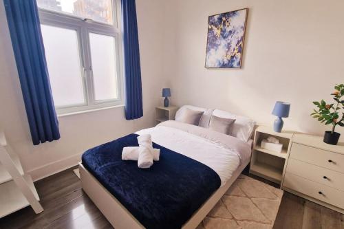 a bedroom with a bed with a stuffed animal on it at 2 Bed Apartment, Near Canary Wharf, O2, Excel, Airport in London