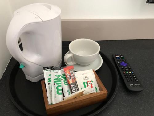 a table with a toilet and a remote control at Studio in Bolton town, Short stay studio 3, in Bolton