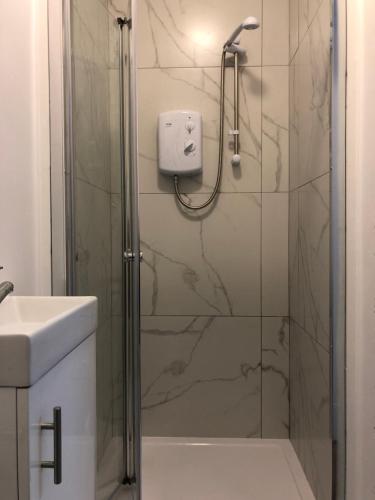 a bathroom with a shower with a glass door at Studio in Bolton town, Short stay studio 3, in Bolton
