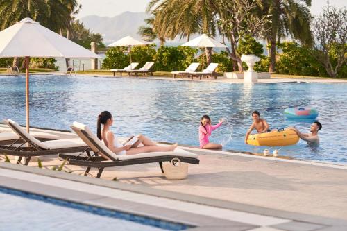 a group of people in the swimming pool at a resort at Nha Trang Marriott Resort & Spa, Hon Tre Island in Nha Trang