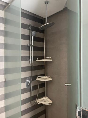 a shower with three shelves on a striped wall at Beautiful View on the sea at Casa-Marina in Casablanca