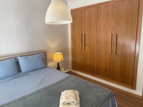 a bedroom with a bed and a cabinet and a lamp at Beautiful View on the sea at Casa-Marina in Casablanca