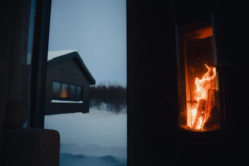 a lantern with a fire in it in front of a window at Svart Lodge in Akureyri