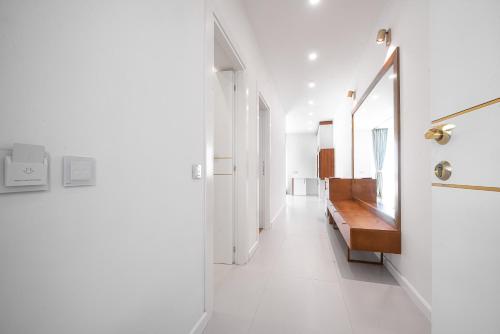 a hallway with white walls and white tile floors at SunRise Beach in Venus
