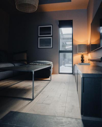 a living room with a table and a couch at Svart Lodge in Akureyri