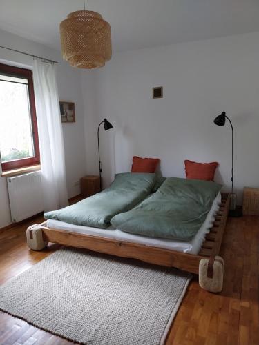 a bed with a wooden frame in a room at Wyciszek - mazurska agroturystyka in Węgorzewo