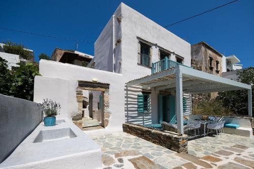 a white house with a balcony and a patio at The Architect's House, 3br villa in Naxos in Naxos Chora