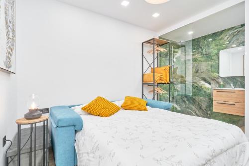 a bedroom with a bed and a glass shower at Aunt Maria's House in Almuñécar
