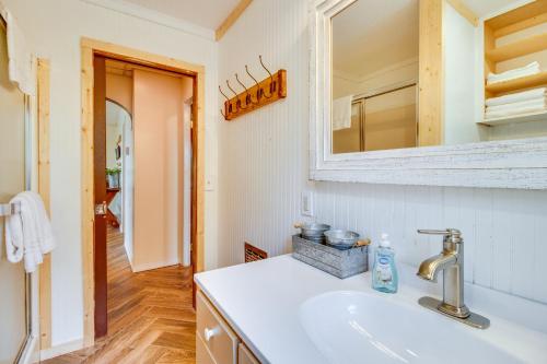 a bathroom with a sink and a mirror at Elizabeth Vacation Rental with Private Hot Tub! in Elizabeth