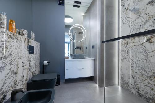 W łazience znajduje się umywalka, toaleta i lustro. w obiekcie HEVENIA POGORZELICA - APARTAMENT 3 w Pogorzelicy