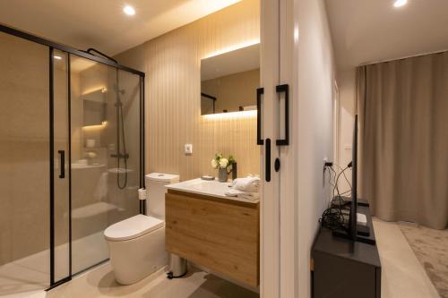 a bathroom with a toilet and a sink and a shower at Dorm4You Centro in Valencia